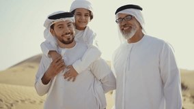 Three generation family spending time in the desert making a safari in Dubai. Concept about middle eastern cultures and lifestyle in the emirates - Powered by Shutterstock - Get 15% off with code: PIKWIZARD15