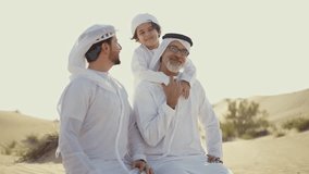 Three generation family spending time in the desert making a safari in Dubai. Concept about middle eastern cultures and lifestyle in the emirates - Powered by Shutterstock - Get 15% off with code: PIKWIZARD15