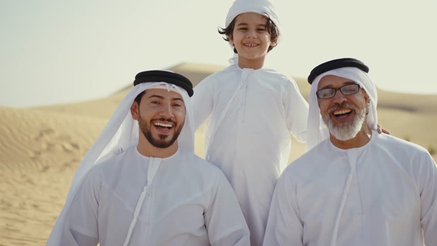 Three generation family spending time in the desert making a safari in Dubai. Concept about middle eastern cultures and lifestyle in the emirates
