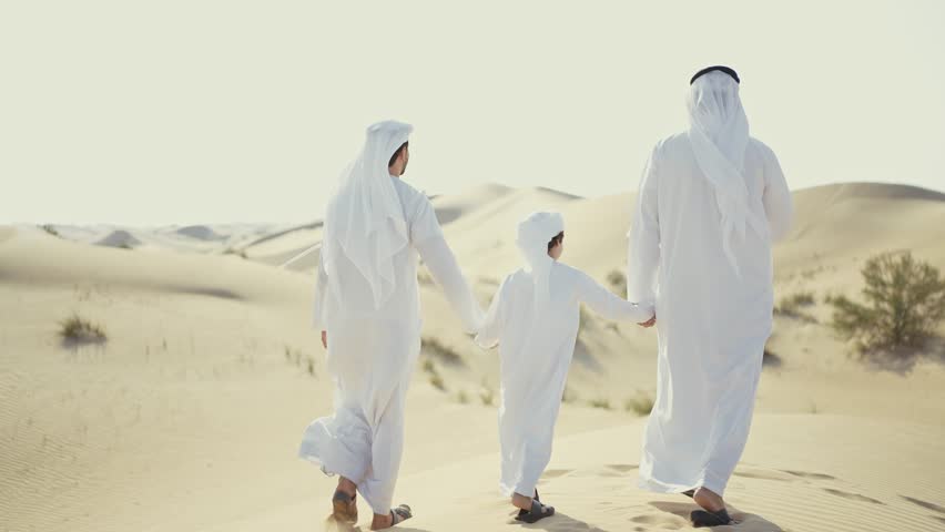 Three generation family spending time in the desert making a safari in Dubai. Concept about middle eastern cultures and lifestyle in the emirates