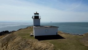 Experience the beauty of the Cape d'Or seaside and Lighthouse with this aerial drone video capturing it perched atop a rocky cliff by the ocean. Absolutely breathtaking!