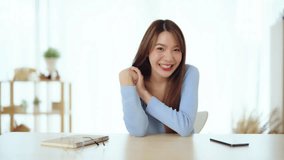 Happy teen asian girl blogger smiling face waving hand talking to webcam recording vlog, social media influencer streaming, making video call at home. Headshot portrait. Webcam view