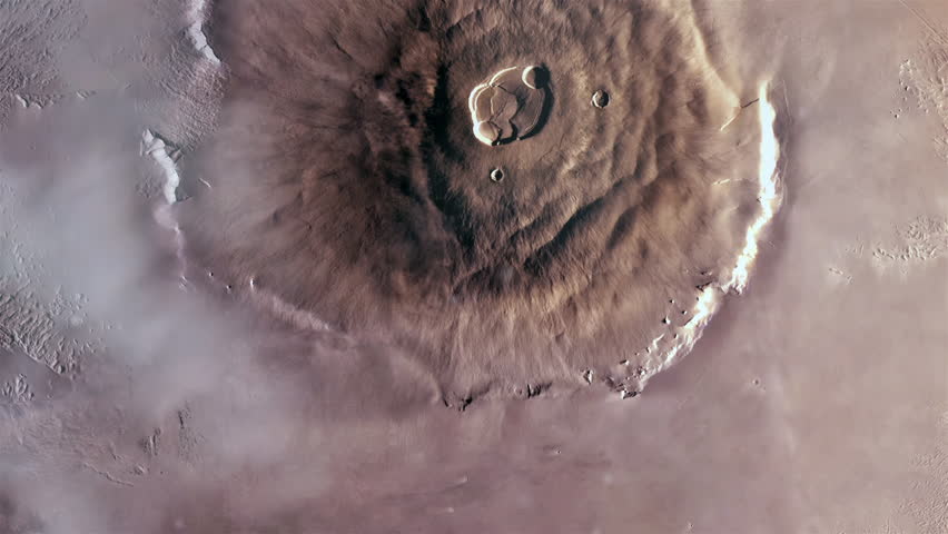 Olympus Mons on Planet Mars, the Largest Volcano in the Solar System with a Height of over 21.9 km (two and a half times the height of Mount Everest). Elements of this Video furnished by NASA. 4K.