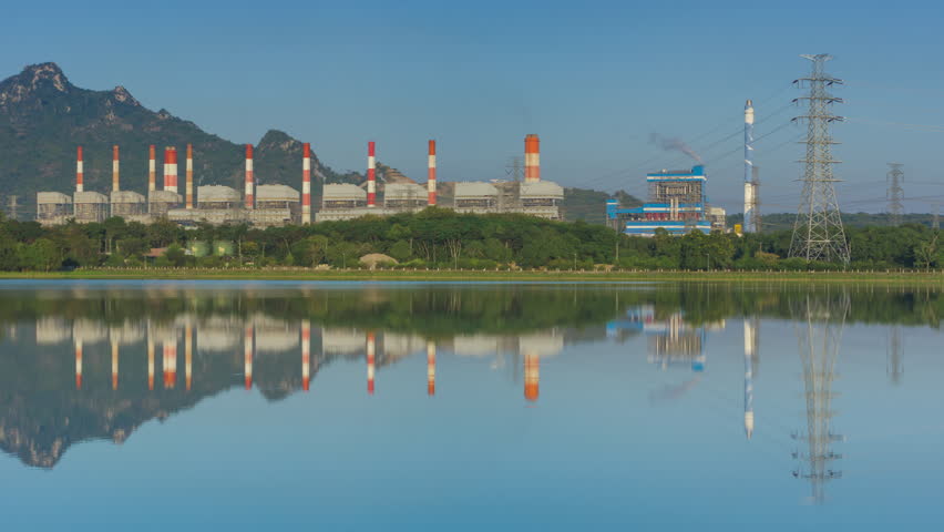 4K time-lapse video motion. Mae Moh Coal Power Plant and lake. The evening light and the moon rise above the smokestack at night. Mar Moh, Lampang, Thailand.