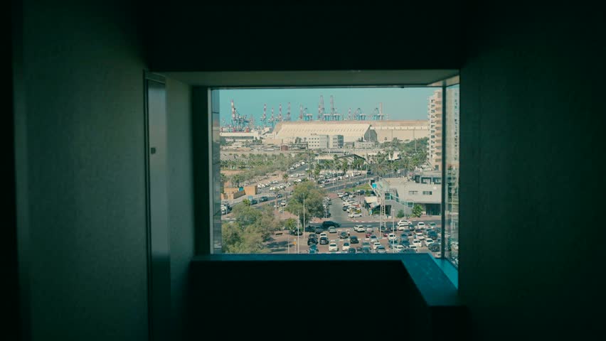 A window with a view of the harbor. View of Ashdod port from the window.