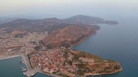 4K aerial - a bird's eye view video (Ultra High Definition) of Nafplion town. Spectacular sunset on Mediterranean sea. Perfect evening scene of Peloponnese peninsula, Greece, Europe.