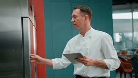 Professional chef using tablet computer recipes while working in modern kitchen cooking concept - Powered by Shutterstock - Get 15% off with code: PIKWIZARD15