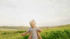 Mom plays with kid outdoors in spring. Baby in arms of mom in sun in park. Motherhood, infant. Happy family, healthy child.Family walk in backyard. Boy kid, mom play together on green grass. Child sun - Powered by Shutterstock - Get 15% off with code: PIKWIZARD15