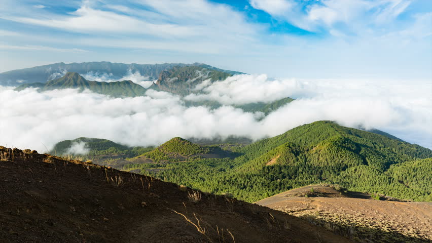 Zooming timelapse sequence of tradewind clouds moving against the mountains of La Palma between the Caldera de Taburiente in the background and the Cumbre Vieja. Seen from the top of the volcano Birig