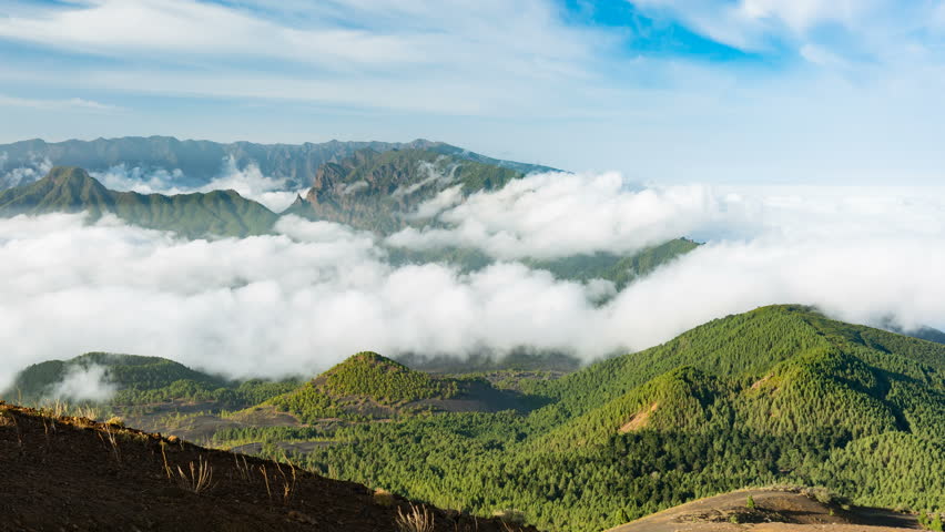 Timelapse sequence of tradewind clouds moving against the mountains of La Palma between the Caldera de Taburiente in the background and the Cumbre Vieja. Seen from the top of the volcano Birigoyo in t