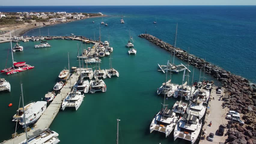 Sailing Boats entering Vlychada marina in Santorini Greece 