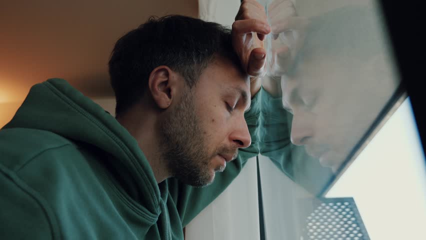 Midlife crisis in men concept. Tired depressed man portrait looking at window with frustrated eyes. Burnout, life problems and male middle age crisis Royalty-Free Stock Footage #1102953413