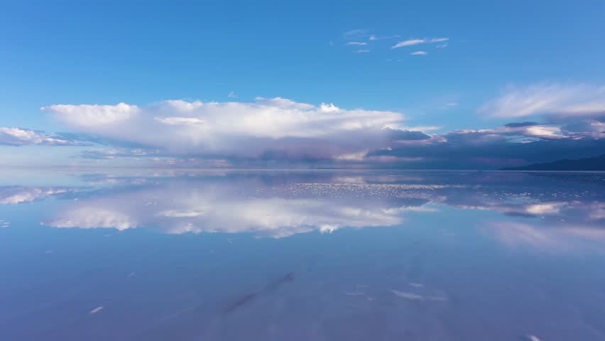 Uyuni Salt Flats. Aerial View. Altiplano, Bolivia. Wet Season. Clouds Reflection on Water in Lake Surface. Drone Flies Forward at Low Level. Wide Shot Royalty-Free Stock Footage #1102962209