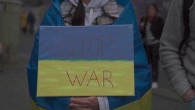 Germany, Munich. Demonstration of Ukrainians against Russia war in Ukraine at Odeonsplatz. Demonstrators contrary invasion of russia into Ukraine. Protest and meeting against war  - Powered by Shutterstock - Get 15% off with code: PIKWIZARD15