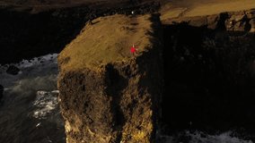Aerial video of a cliff landscape with people looking at the landscape