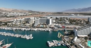 Aerial footage of boats moored in Eilat's marina near the hotels. Filmed in C4K Apple ProRes 422 HQ