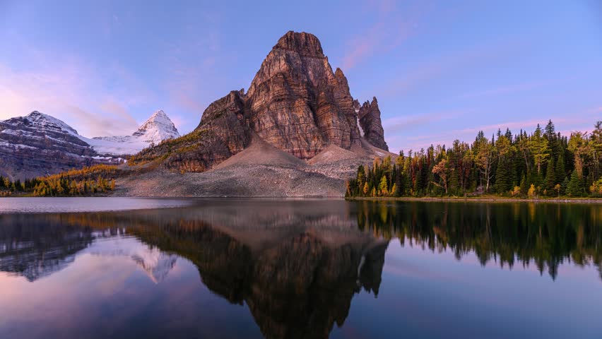 Time lapse of Beautiful Sunburst Lake with Mount Assiniboine reflection in autumn forest on provincial park at BC, Canada