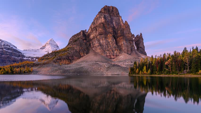 Time lapse of Beautiful Sunburst Lake with Mount Assiniboine reflection in autumn forest on provincial park at BC, Canada