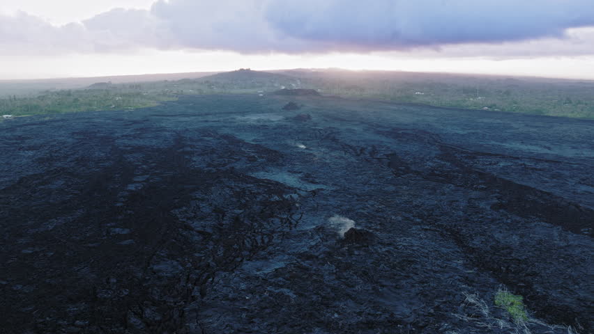 Helicopter aerial of eruption of the Kilauea volcano on Big Island, Hawaii state, USA 4K aerial travel destination. Scenic black burnt aftermath landscape of Pahoa city by volcano eruption in 2018