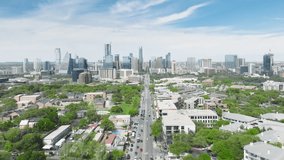 Downtown Austin cityscape on sunny summer day, Texas 4K aerial USA. Austin skyscraper buildings skyline video. Drone flying above road in suburban area towards scenic tall business offices buildings