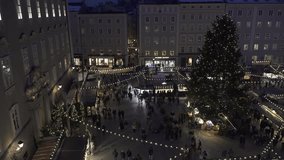 Night video of Residenzplatz square during the traditional Christmas market in Salzburg, Austria. High angle shot.