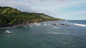 Bali, Indonesia: Aerial drone footage of the coastline of Candidasa, a beach town in eastern Bali in Indonesia in later afternoon light. Shot as an hyper laspe video