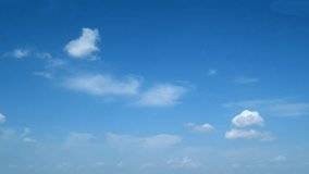 White clouds float across the blue sky. Puffy fluffy soft clouds. Timelapse. - Powered by Shutterstock - Get 15% off with code: PIKWIZARD15