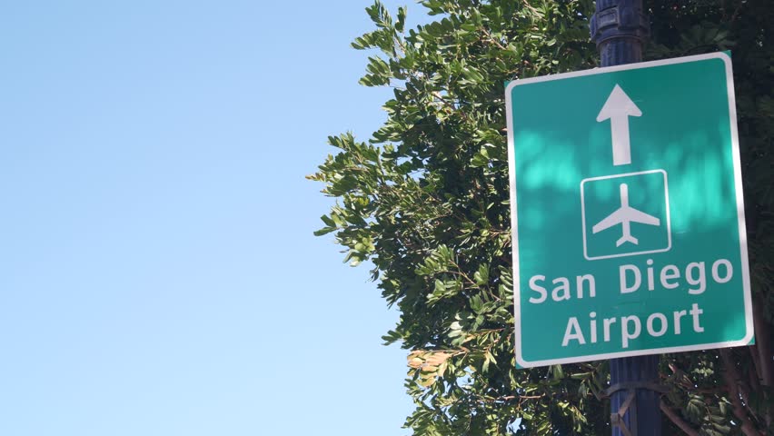 Airport green road sign with direction arrow and plane icon, San Diego city street, California USA. Tourist destination, traffic signage. Local and international traveling concept. | Shutterstock HD Video #1102976223