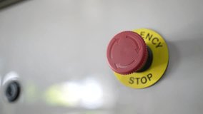 Man's hand pressing the emergency stop button - Powered by Shutterstock - Get 15% off with code: PIKWIZARD15