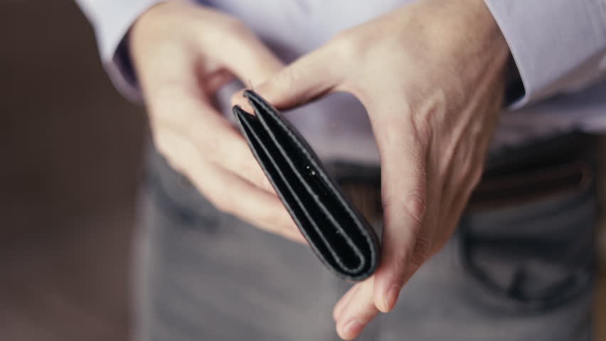 empty wallet in the hands of a man. There is no money. small salary, family budget. Poor work, high pay, problems at work. Sad person, depression. Financial problems