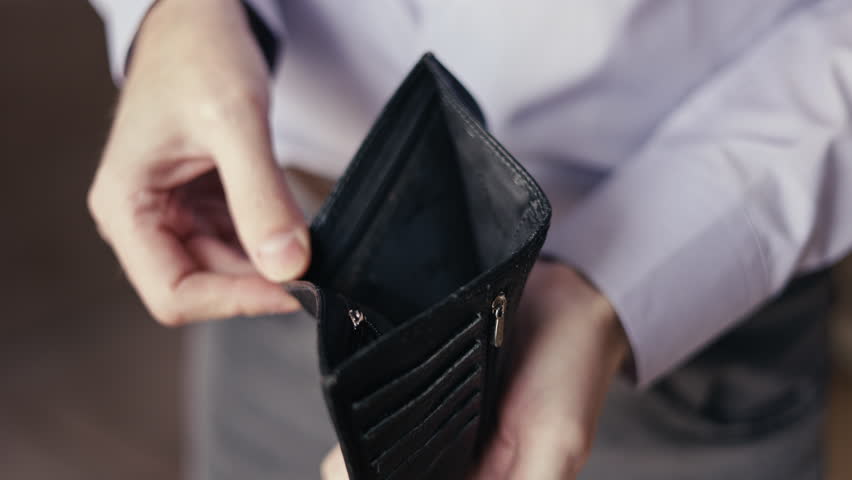 empty wallet in the hands of a man. There is no money. small salary, family budget. Poor work, high pay, problems at work. Sad person, depression. Financial problems