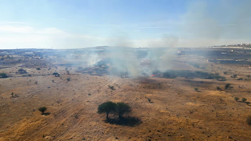 Aerial view of drought causing wildfires in bushes and dry wildland nature
