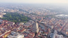 Inscription on video. Turin, Italy. Flight over the city. Mole Antonelliana - a 19th-century building with a 121 m high dome and a spire. Different colors letters appears behind small squares, Aerial