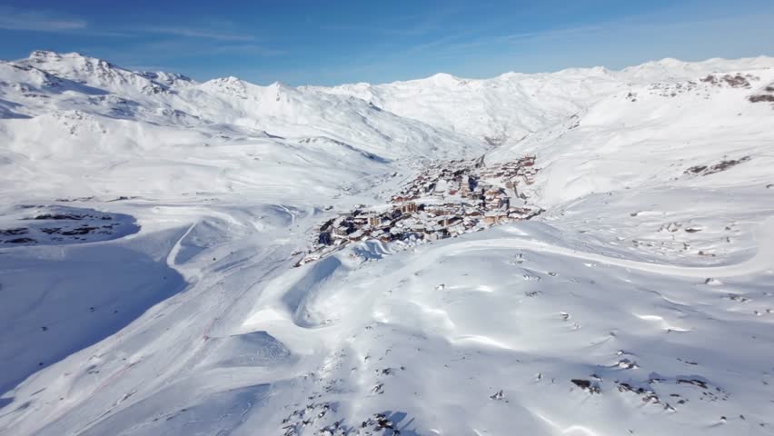 Val Thorens, France.
 Aerial view of the ski resort and the village .mountains in winter, blue sky, sunny day with lot of snow . Royalty-Free Stock Footage #1102981075