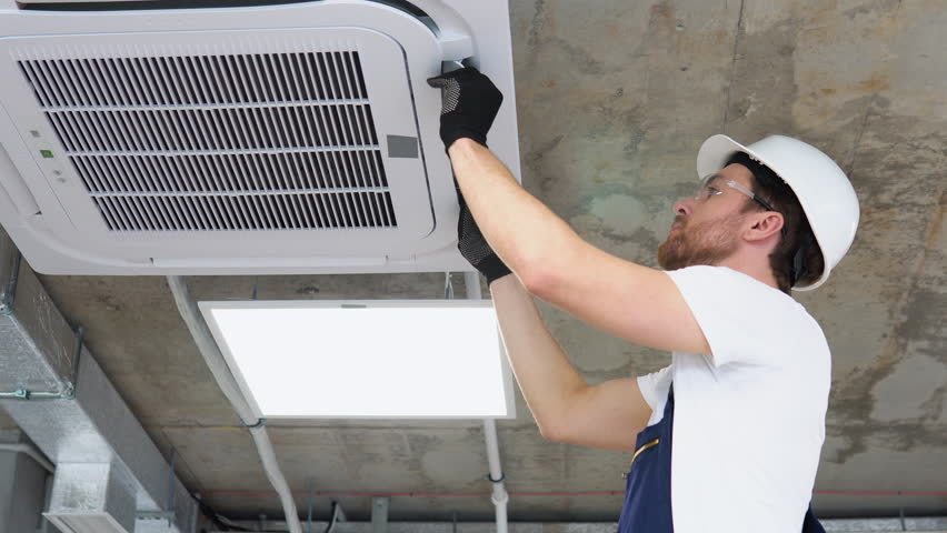 Professional technician maintaining modern air conditioner in office Royalty-Free Stock Footage #1102981441