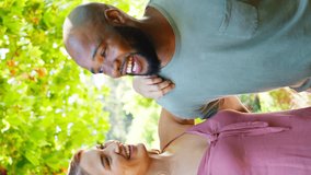 Vertical video portrait of happy and loving multi-racial senior couple outside in park, garden or countryside - shot in slow motion - Powered by Shutterstock - Get 15% off with code: PIKWIZARD15