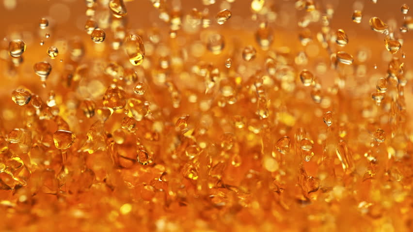 Amber Whisky Splashing in Slow Motion - Abstract Golden Energetically Bouncing Liquid Makes Droplets and Splashes Royalty-Free Stock Footage #1102987893