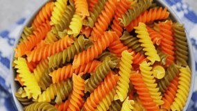 Raw colorful italian fusilli pasta. Colorful fusilli pasta with durum wheat, close up. Boom shot