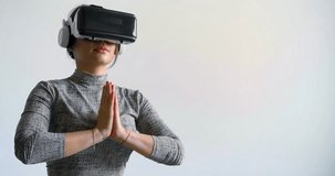 Close-up of a young woman meditating in vr glasses. A woman practices yoga and meditation using glasses with virtual reality technology. Modern technologies for the restoration of mental health.