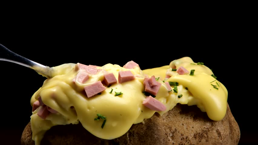 Baked potato with cheese an ham Royalty-Free Stock Footage #1103002381