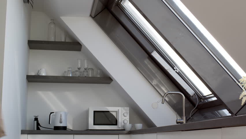 Eco shopping concept. Young pretty lady coming to kitchen with craft paper bag and getting boxes with food out, going to fridge, empty space