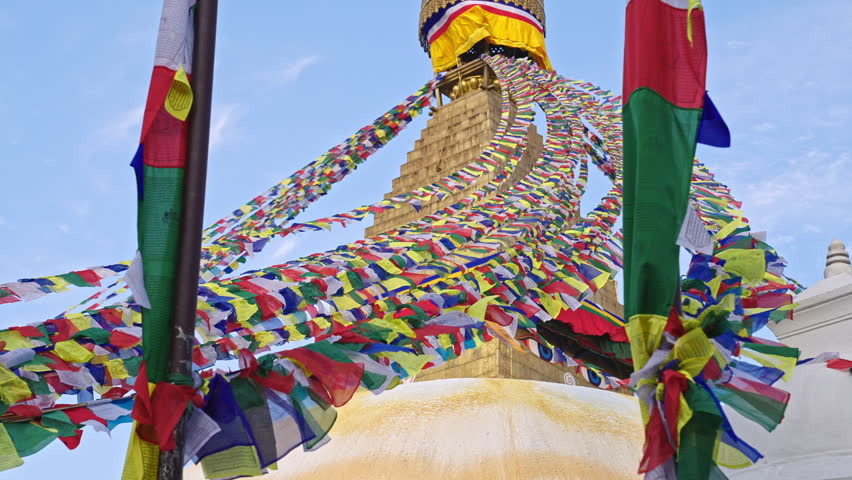 Hundreds of colorful prayer flags blowing with the wind in slow motion at Boudhanath Stupa, Kathmandu, Nepal