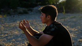 Young man prayer videos, worshiping in nature, different religions and beliefs, hand open and praying to god, beliefs and faithful, wishing to god