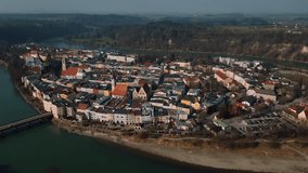Wasserburg am Inn, old medieval town in Bavaria, Germany, surrounded by green river bend. Aerial drone footage of European houses, castle, bridge, church and market square in early morning fog. 4K UHD