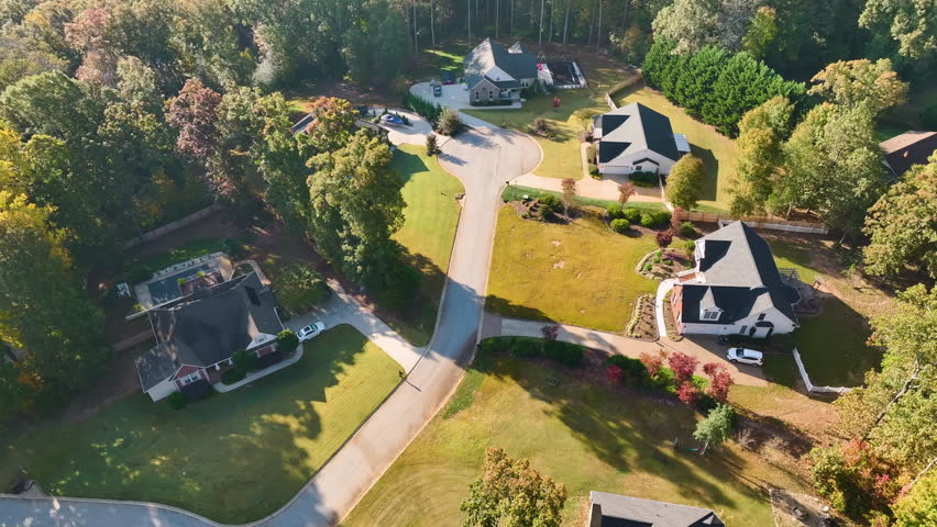 Aerial view of new family houses between yellow trees in South Carolina suburban area in fall season. Real estate development in american suburbs Royalty-Free Stock Footage #1103015205