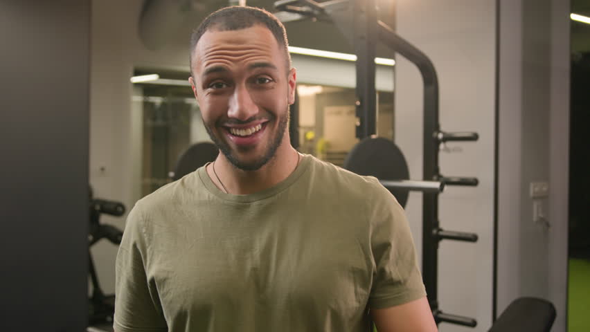 Smiling African American man personal fitness trainer invite to gym workout sportsman athlete welcome come here gesture invitation to join training posing crossed arms in gym sport club bodybuilder Royalty-Free Stock Footage #1103025143