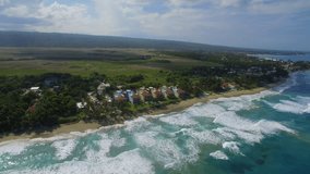 Aerial footage of Cabarete, Dominican Republic, capturing vibrant beach town, azure Caribbean Sea, water sports, and lush coastline. Perfect for travel and adventure projects.