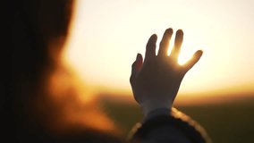 Silhouette of happy dreaming girl pulls her hand to sun.Religion helping hand. Happy girl pulls her hand.Prayer in religion.Silhouette of hand in sun.Happy girl silhouette at sunset.Freedom in nature - Powered by Shutterstock - Get 15% off with code: PIKWIZARD15