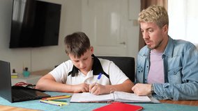Father helping his son with school homework. Parenting concept
