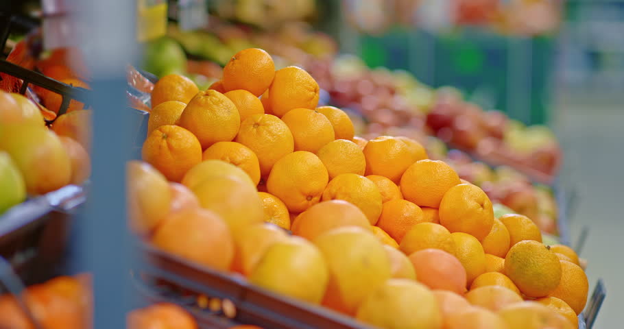 tangerines in supermarket shelf, closeup view, man is taking fruits in food market, 4K, Prores